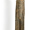 an old wooden statue of a man with a hat and a robe