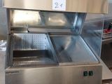 a stainless steel counter top with a glass case on it