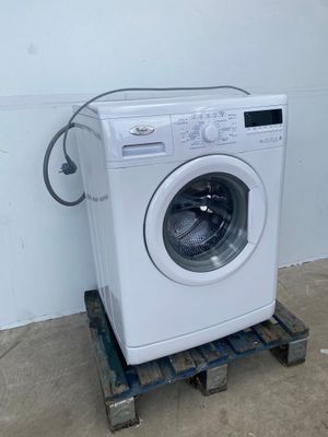 an image of a washing machine sitting on top of a pallet
