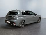 the rear view of a grey car in a white room