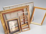 three different sized picture frames sitting next to each other on a table