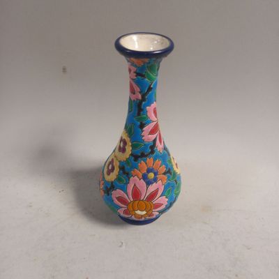 un petit vase bleu orné d'un motif floral