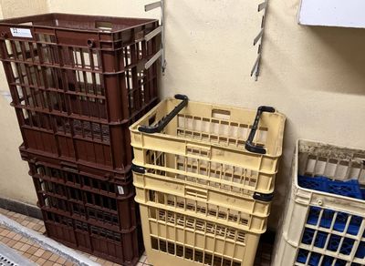 three plastic crates sitting next to each other on the floor