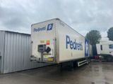 a semi truck that is parked in front of a building