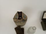 an image of a pair of gloves, a watch and a bottle of water on a table