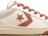 a close up of a pair of sneakers with a star on the side