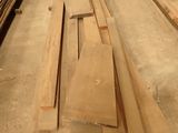 several pieces of wood are stacked on top of each other in a warehouse