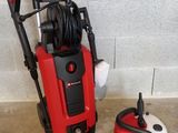 an image of a red and black pressurer next to a cleaning machine
