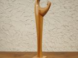 a wooden sculpture of a person on a wooden table