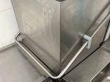 a sink in the corner of a kitchen with a pot on top of it
