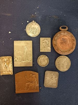 some of the gold medals are on display on a blue surface