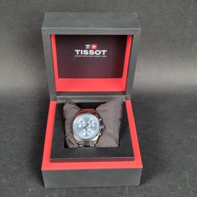the watch is in a box on the table ready to be used