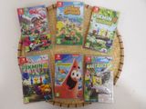 des jeux Nintendo Wii dans un panier en osier posé sur une table