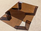 a glass table that has a mirror on top of it
