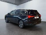 the rear of a black bmw suv parked in a garage