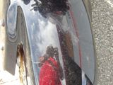 a reflection of a person in a mirror on the side of a motorcycle