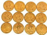 a close up of a bunch of gold coins on a white surface