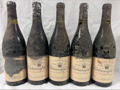 six bottles of wine are lined up in a row on a table
