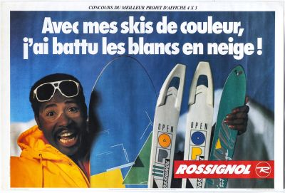 a man in a yellow jacket holding a pair of skis