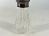 an antique glass salt and pepper shaker with a silver lid