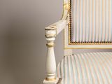 an image of a white chair with a striped upholstered seat