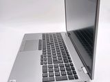 a silver laptop with a black keyboard on a white surface