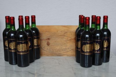 six bottles of wine are lined up in a row on a table