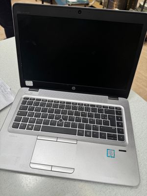 an open laptop computer sitting on top of a table next to a cup of coffee