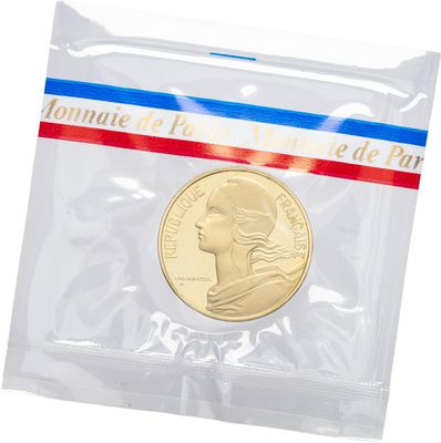 a close up of a coin in a plastic bag on a white background