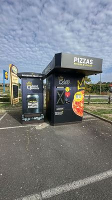 a black box with a pizza on it in a parking lot