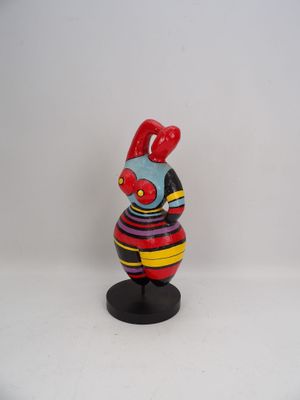 a small figurine of a rooster on a stand