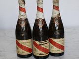 three bottles of beer sitting on top of a marble counter top