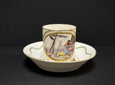 a cup and saucer with a picture of a boat on it
