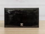 a black wallet with a small logo on the front