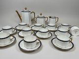 many cups and saucers that are sitting on the table