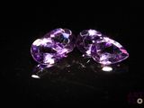 pair of purple amethtites on a black surface