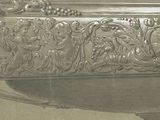 a silver bowl with a design on it