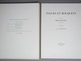 an old book opened to show the contents of a florist bouquet