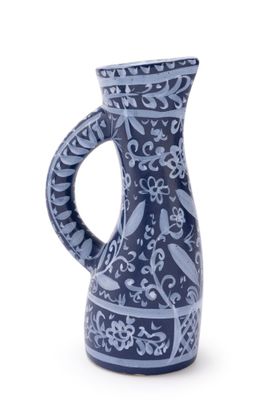 a blue and white vase with a handle on a white background