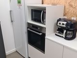 a small kitchen with a microwave and a coffee maker