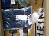 a cardboard box filled with many different types of clothing