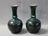 two vases sitting side by side on a table