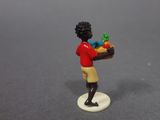 a small figurine of a boy holding a basket of fruit
