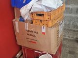 a stack of boxes on a pallet next to a red wall