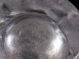 a close up of a metal object with a hole in it