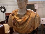 a bust of a man sitting on a table in a room