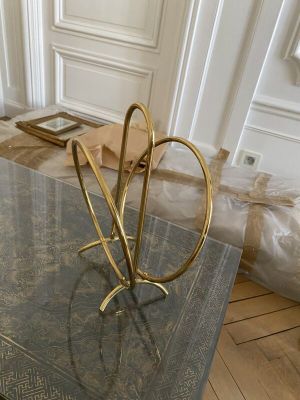 a marble table with a gold sculpture on it