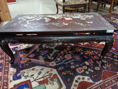 a coffee table that is on a rug in a room