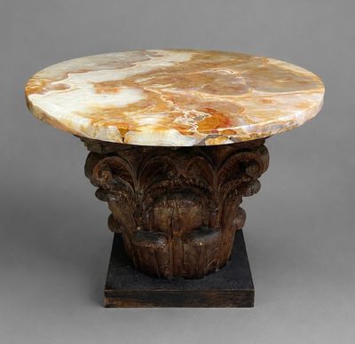a marble table with a wooden base on a gray surface