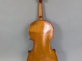 an old violin sitting on top of a table next to a wall